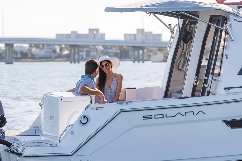  Yacht Photos Pics Couple enjoying a sunny day on a 2025 Solara S-250 Coupe boat.