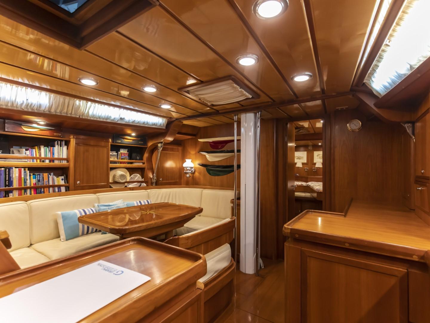 Luxurious interior of 2002 Sloop Starkel Star 60 yacht with wooden furnishings and cozy seating.