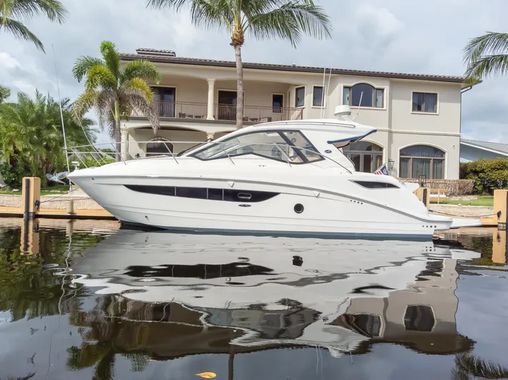  Yacht Photos Pics 2019 Sea Ray Sundancer 350 Coupe docked by a waterfront home.
