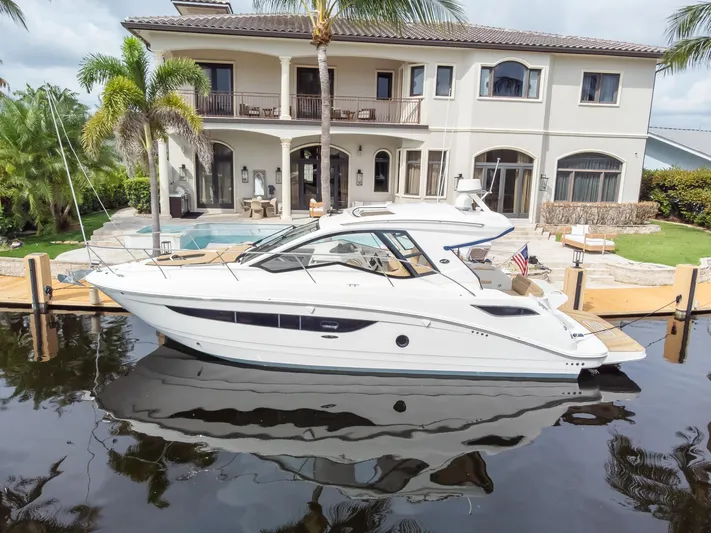  Yacht Photos Pics 2019 Sea Ray Sundancer 350 Coupe docked by a luxurious waterfront home.