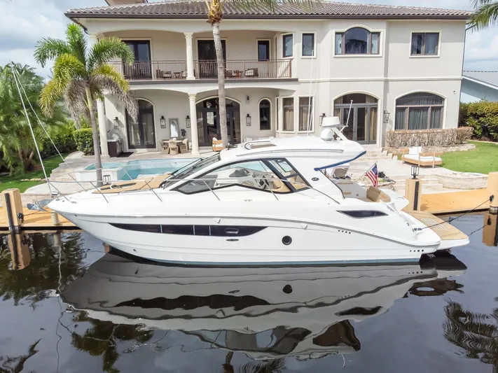  Yacht Photos Pics 2019 Sea Ray Sundancer 350 Coupe docked by luxurious waterfront home.
