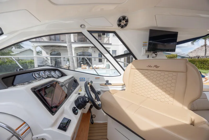  Yacht Photos Pics 2019 Sea Ray Sundancer 350 Coupe cockpit with luxurious seating and modern dashboard.