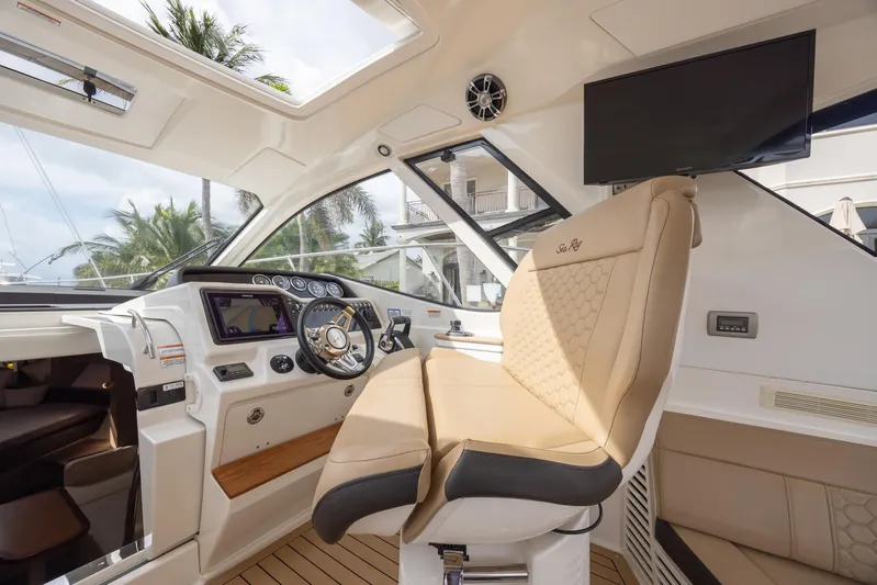  Yacht Photos Pics 2019 Sea Ray Sundancer 350 Coupe helm with luxurious seating and modern controls.