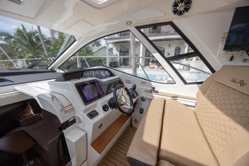  Yacht Photos Pics 2019 Sea Ray Sundancer 350 Coupe cockpit with modern controls and luxurious seating.