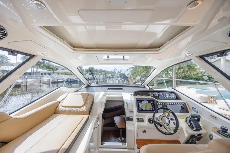  Yacht Photos Pics Luxurious interior of 2019 Sea Ray Sundancer 350 Coupe yacht with modern helm and seating.