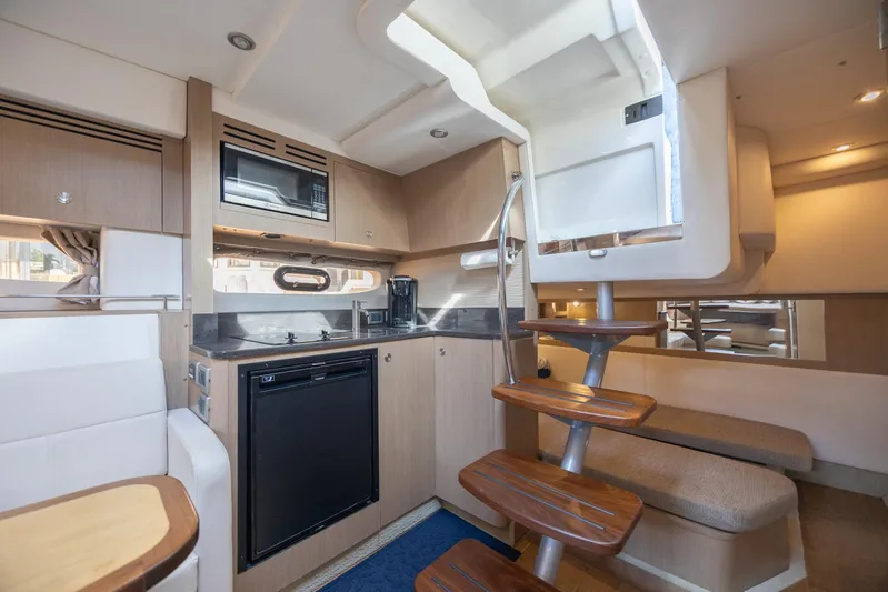  Yacht Photos Pics 2019 Sea Ray Sundancer 350 Coupe interior with modern kitchen and wooden staircase.