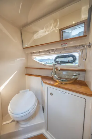  Yacht Photos Pics 2019 Sea Ray Sundancer 350 Coupe bathroom with modern glass sink and porthole window.