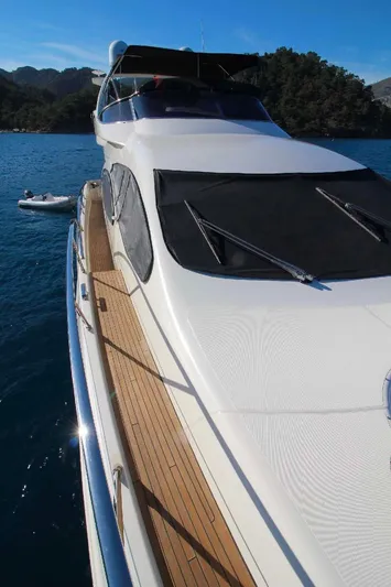  Yacht Photos Pics Azimut 68 FLY 2007 yacht on serene blue water with scenic backdrop.