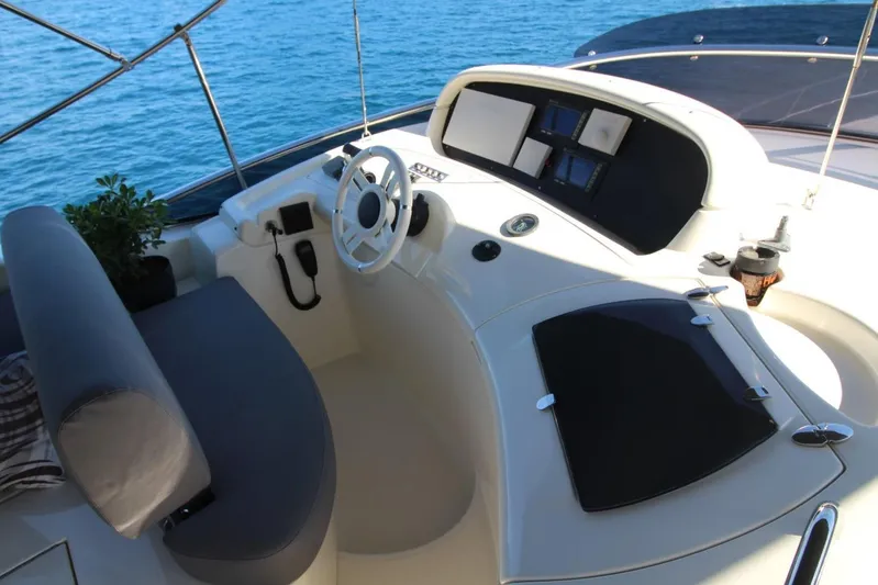  Yacht Photos Pics Cockpit of 2007 Azimut 68 FLY yacht with steering wheel and navigation controls.
