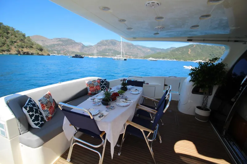  Yacht Photos Pics Luxurious dining setup on 2007 Azimut 68 FLY yacht with scenic ocean view.
