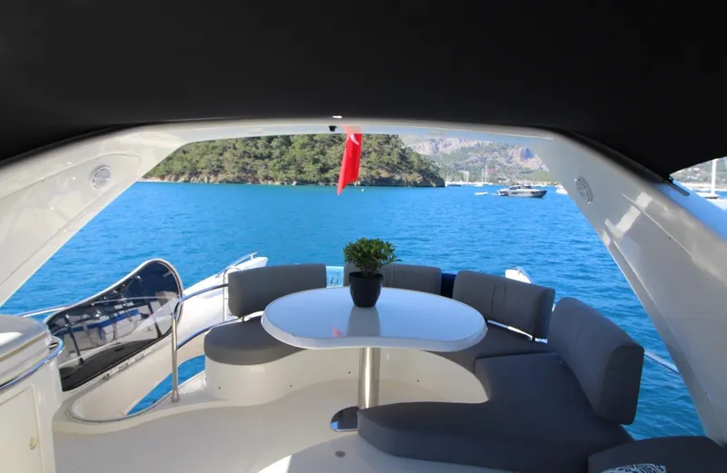  Yacht Photos Pics Luxurious 2007 Azimut 68 FLY yacht with elegant seating, overlooking serene blue waters.