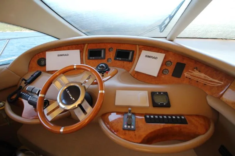  Yacht Photos Pics Cockpit of 2007 Azimut 68 FLY yacht with wooden steering wheel and navigation controls.