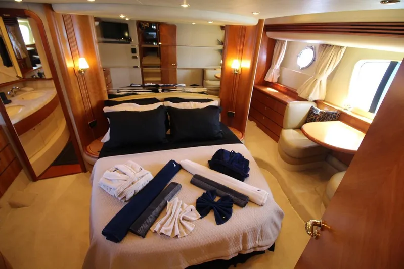  Yacht Photos Pics Luxurious 2007 Azimut 68 FLY yacht bedroom with elegant decor and cozy seating area.