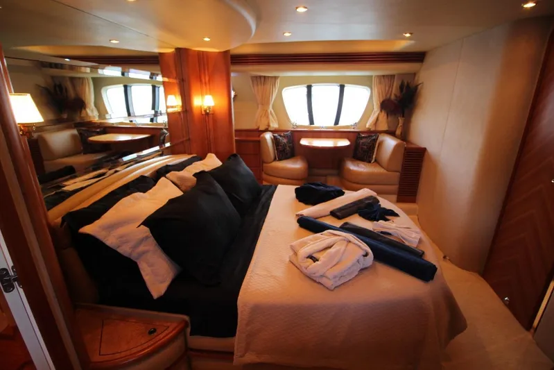  Yacht Photos Pics Luxurious bedroom interior of 2007 Azimut 68 FLY yacht with elegant furnishings and ambient lighting.
