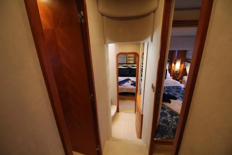  Yacht Photos Pics Interior hallway of 2007 Azimut 68 FLY yacht, featuring wood doors and cozy bedrooms.