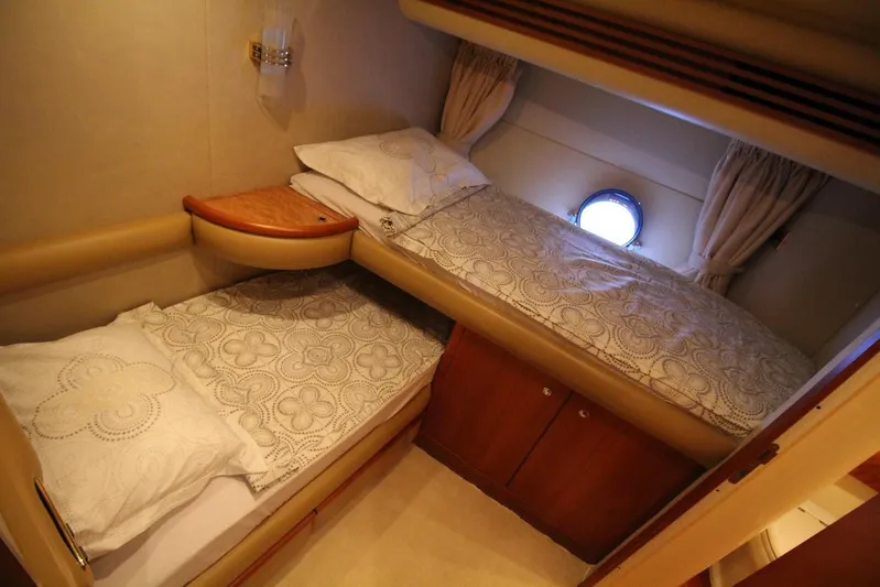  Yacht Photos Pics Twin cabin interior of 2007 Azimut 68 FLY yacht with porthole and bedding.
