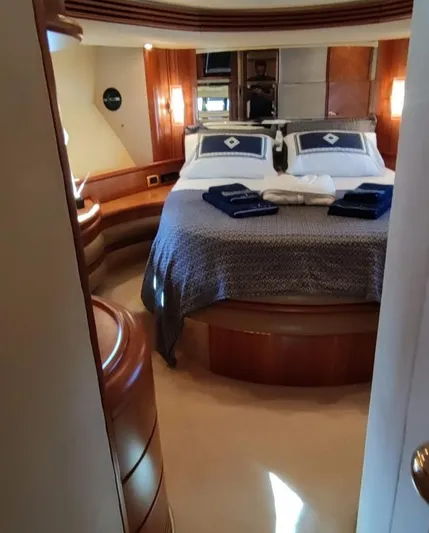  Yacht Photos Pics Luxurious bedroom interior of 2007 Azimut 68 FLY yacht with elegant wood finishes.