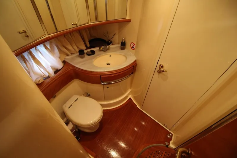  Yacht Photos Pics Luxurious bathroom in 2007 Azimut 68 FLY yacht with elegant fixtures and wood flooring.