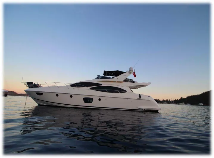  Yacht Photos Pics 2007 Azimut 68 FLY yacht on calm water at sunset.