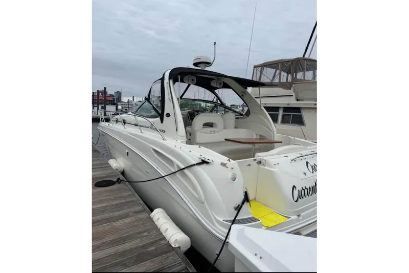  Yacht Photos Pics 2003 Sea Ray 360 Sundancer docked, showcasing sleek design and spacious deck area.