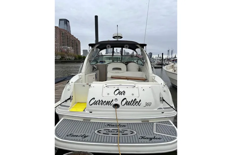  Yacht Photos Pics 2003 Sea Ray 360 Sundancer docked, rear view with cityscape background.