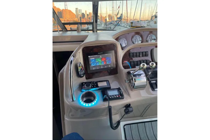  Yacht Photos Pics Helm of 2003 Sea Ray 360 Sundancer with navigation controls and city skyline view.