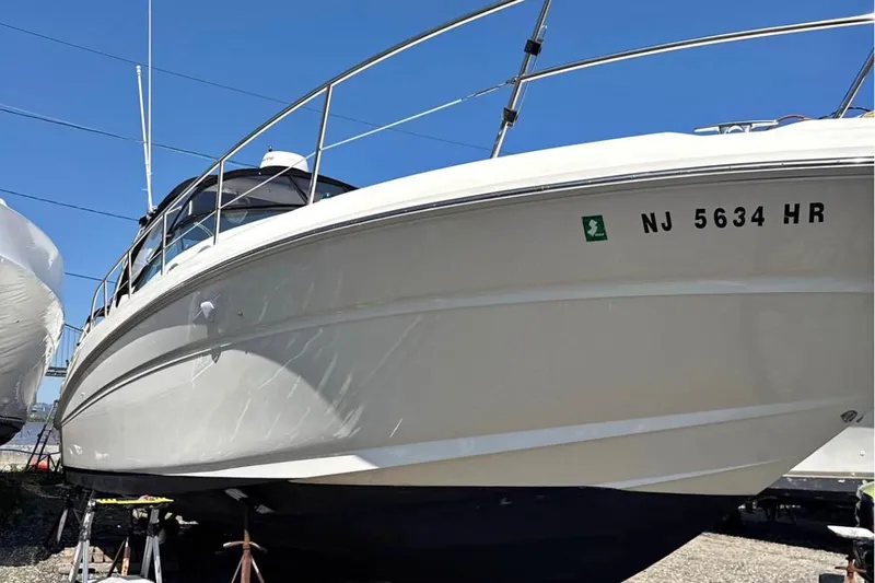  Yacht Photos Pics 2003 Sea Ray 360 Sundancer boat on stands, clear sky background.