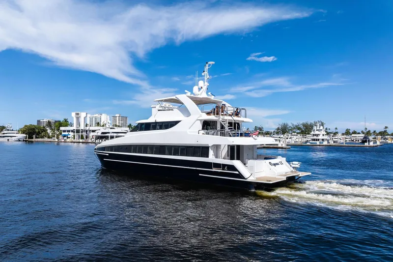 Pegasus Ix Yacht Photos Pics Luxurious 2004 Sabre 92 yacht cruising in a scenic marina under a clear blue sky.