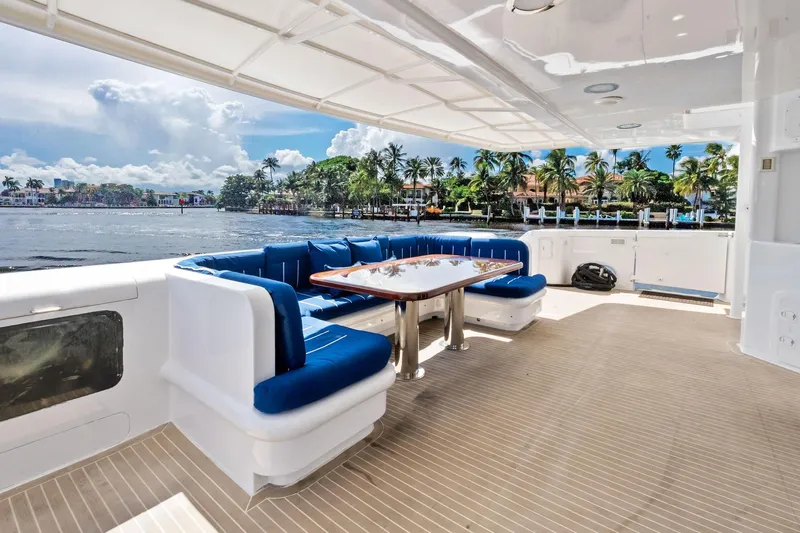 Pegasus Ix Yacht Photos Pics Luxurious 2004 Sabre 92 yacht deck with blue seating, table, and scenic waterfront view.
