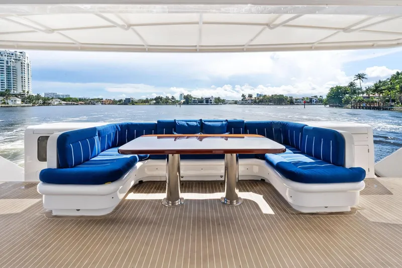 Pegasus Ix Yacht Photos Pics Luxurious Sabre 92 yacht deck with blue seating and scenic waterfront view, 2004 model.