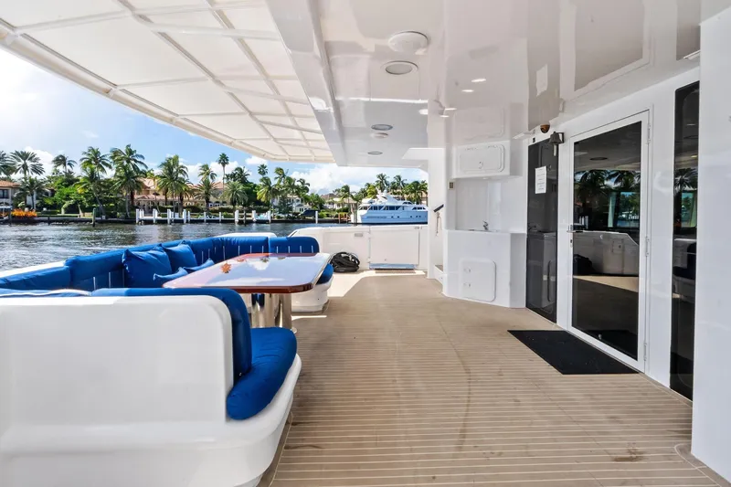 Pegasus Ix Yacht Photos Pics Luxurious 2004 Sabre 92 yacht deck with blue seating, table, and waterfront view.