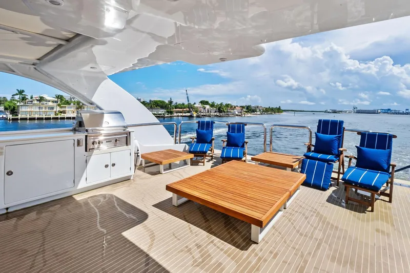 Pegasus Ix Yacht Photos Pics Luxurious 2004 Sabre 92 yacht deck with blue lounge chairs and barbecue grill.