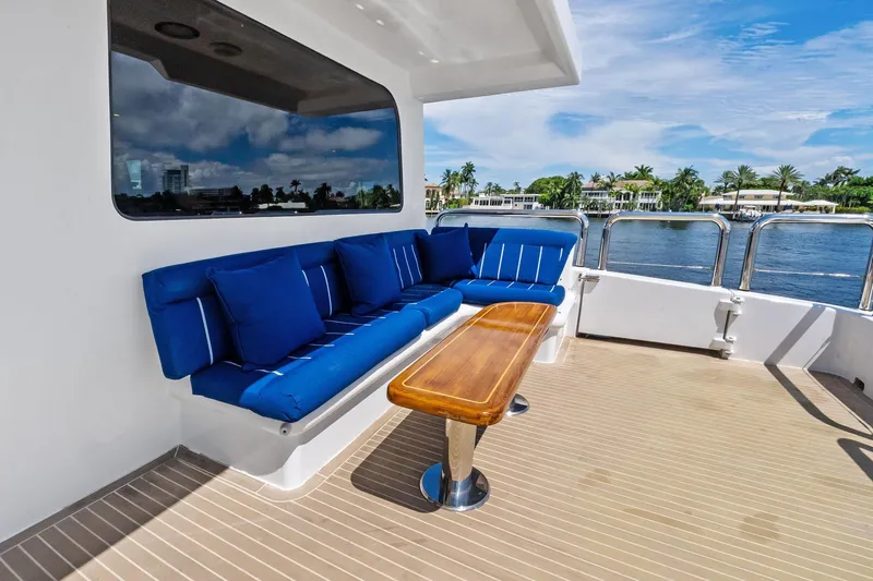 Pegasus Ix Yacht Photos Pics Luxury Sabre 92 yacht deck with blue seating and wooden table, 2004 model.