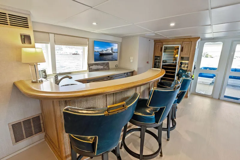 Pegasus Ix Yacht Photos Pics Luxurious yacht interior with bar, blue stools, and scenic window view, Sabre 92, 2004 model.