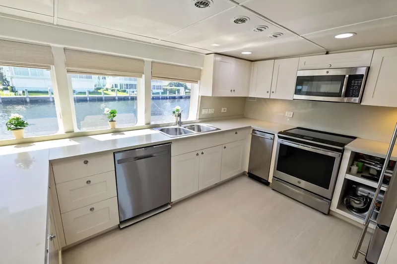 Pegasus Ix Yacht Photos Pics Modern kitchen interior on a 2004 Sabre 92 yacht, featuring stainless steel appliances and waterfront view.