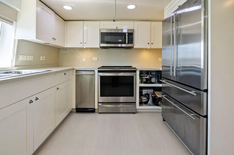 Pegasus Ix Yacht Photos Pics Modern kitchen with stainless steel appliances, white cabinets, and sleek countertops. Sabre 92, 2004.