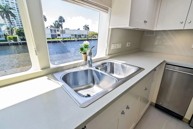 Pegasus Ix Yacht Photos Pics Modern yacht kitchen with stainless steel sink, dishwasher, and waterfront view. Sabre 92, 2004 model.