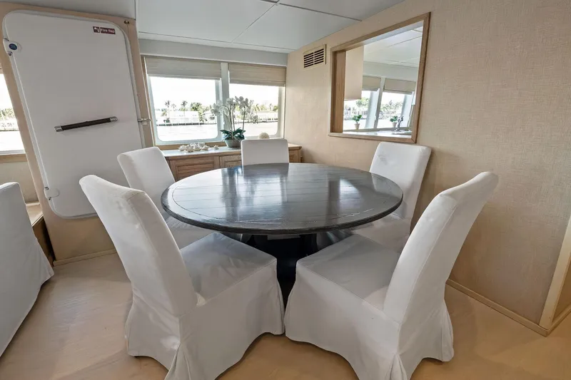 Pegasus Ix Yacht Photos Pics Dining area in 2004 Sabre 92 yacht with round table and white chairs.