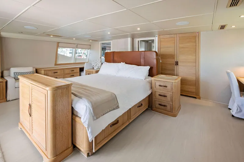 Pegasus Ix Yacht Photos Pics Luxurious bedroom interior on 2004 Sabre 92 yacht, featuring elegant wood furnishings and modern design.
