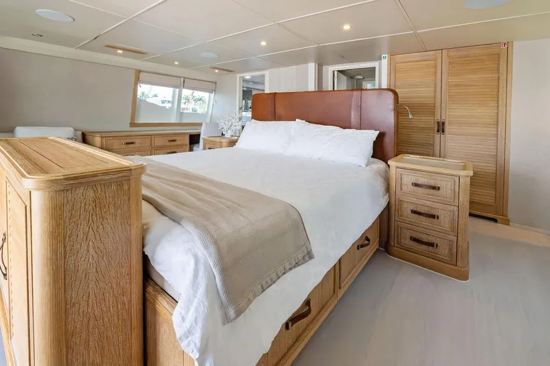 Pegasus Ix Yacht Photos Pics Luxurious bedroom interior on 2004 Sabre 92 yacht with wooden furnishings and cozy bedding.