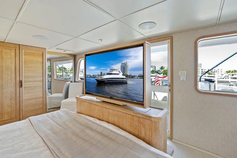 Pegasus Ix Yacht Photos Pics Luxurious Sabre 92 yacht interior, featuring a cozy bedroom with a large TV, 2004 model.