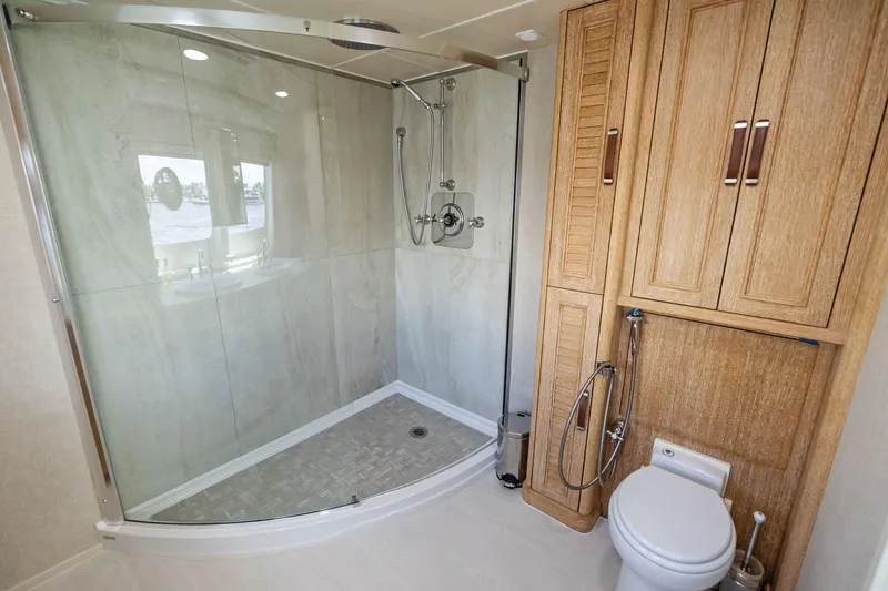 Pegasus Ix Yacht Photos Pics Luxurious bathroom in 2004 Sabre 92 yacht with glass shower and wooden cabinetry.