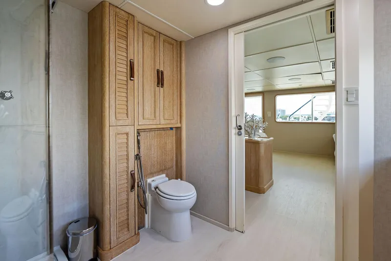 Pegasus Ix Yacht Photos Pics Luxurious bathroom on 2004 Sabre 92 yacht with wooden cabinetry and modern fixtures.