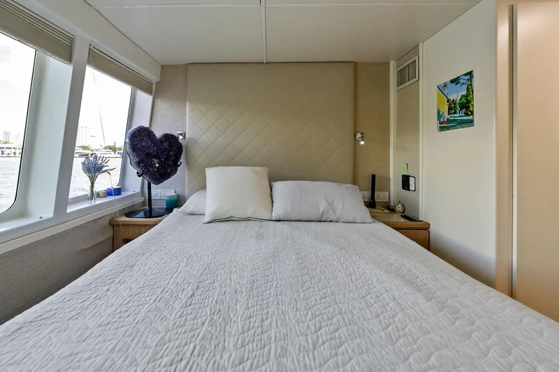 Pegasus Ix Yacht Photos Pics Luxurious bedroom interior on 2004 Sabre 92 yacht with large windows and elegant decor.