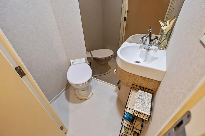 Pegasus Ix Yacht Photos Pics Compact bathroom in 2004 Sabre 92, featuring toilet, sink, and storage shelves.