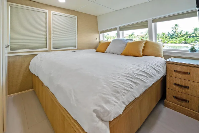 Pegasus Ix Yacht Photos Pics Luxurious bedroom interior on a 2004 Sabre 92 yacht with large windows and cozy bedding.