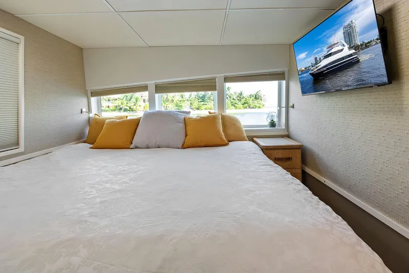 Pegasus Ix Yacht Photos Pics Luxurious bedroom interior on 2004 Sabre 92 yacht with cozy bedding and wall-mounted TV.