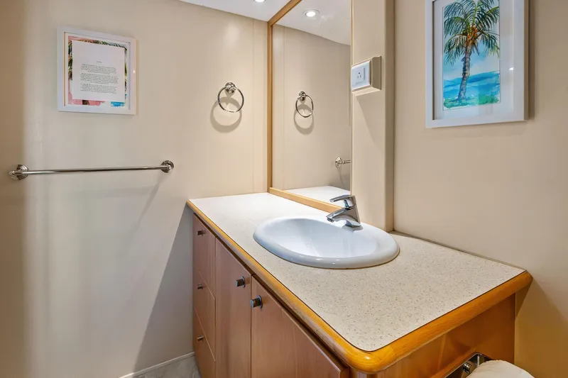 Pegasus Ix Yacht Photos Pics Modern bathroom vanity in a 2004 Sabre 92 yacht, featuring a sleek sink and framed artwork.
