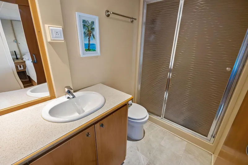 Pegasus Ix Yacht Photos Pics Modern bathroom in 2004 Sabre 92 yacht with shower, sink, and tropical artwork.