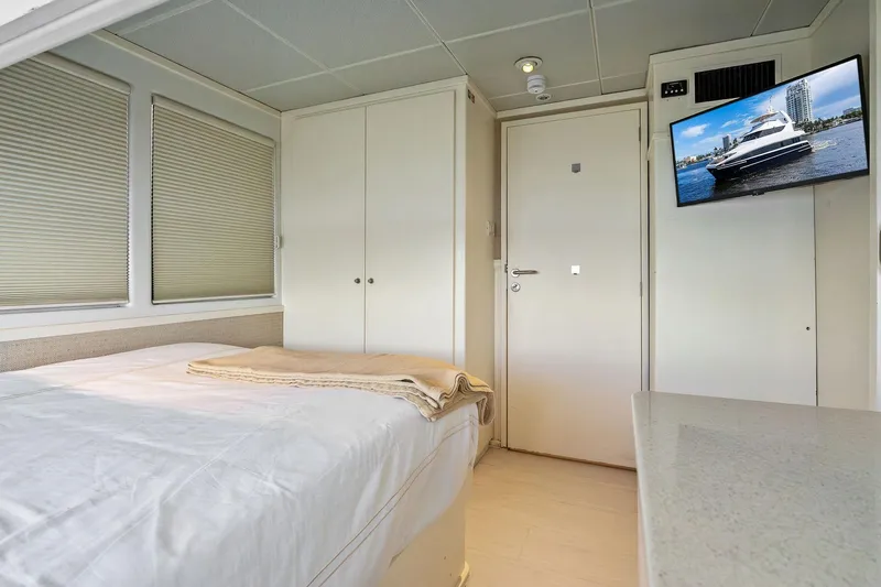 Pegasus Ix Yacht Photos Pics Interior of 2004 Sabre 92 yacht bedroom with bed, TV, and closet.